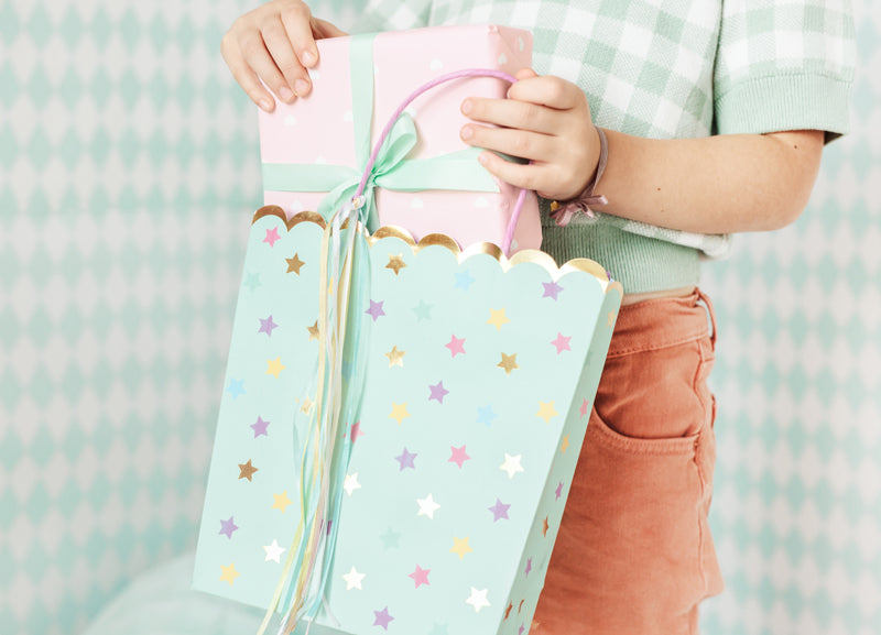 Party bags/gift bags made of paper in turquoise with stars